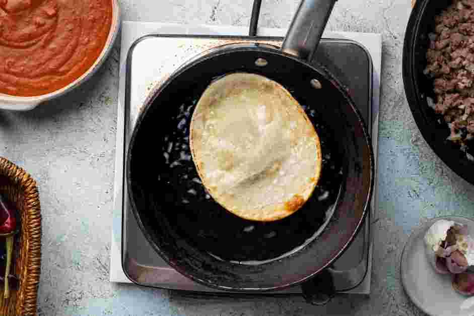 Enchiladas Rojas Recipe: Heat oil in a shallow pan.