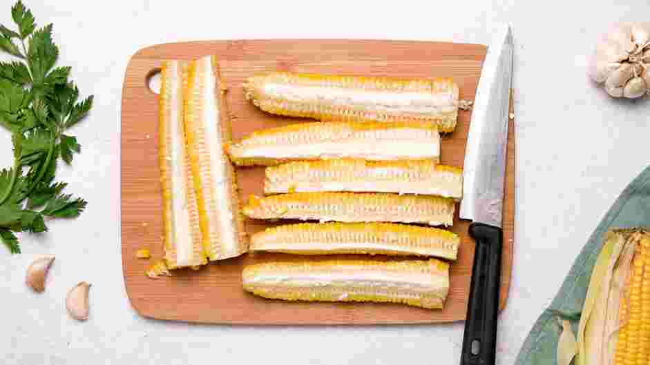 Corn Ribs Recipe: Stand the half of the corn on its stem end and use the same rocking motion to cut the corn into quarters.