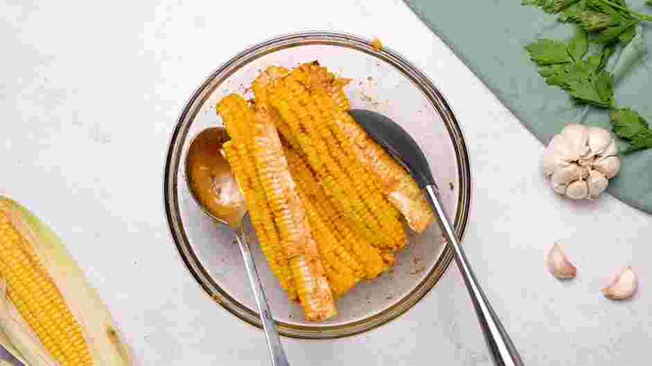 Corn Ribs Recipe: Add the cut corn into the bowl and toss to coat evenly.