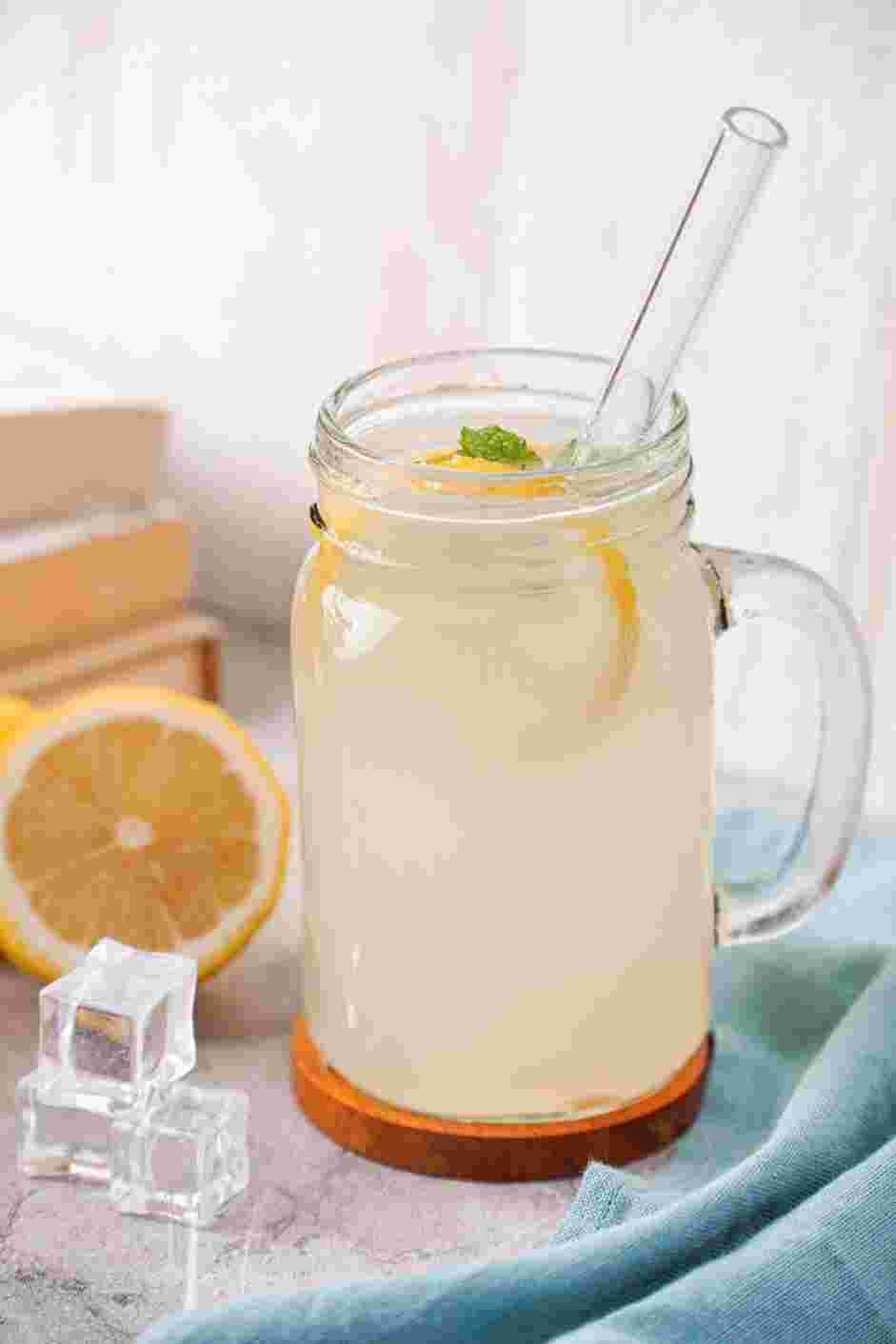 Frozen Lemonade Recipe: Serve immediately in a tall glass garnished with mint leaves and lemon slices.