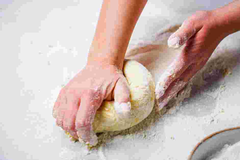 Potato Gnocchi with Butter and Herbs Recipe: Begin to knead the dough together, only add more flour as needed to keep the dough from becoming too wet.