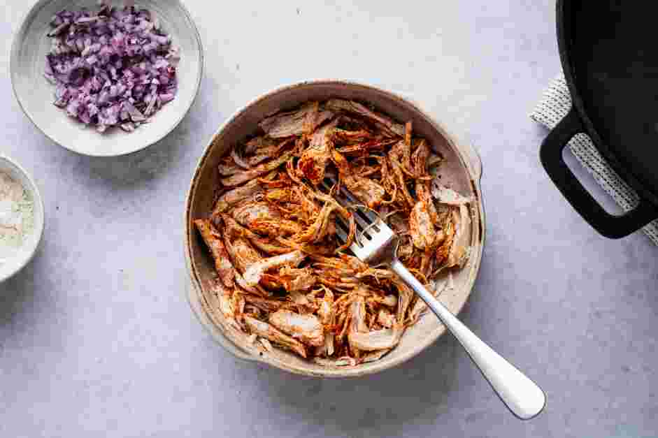 Chicken Flautas Recipe: Transfer the shredded chicken to a bowl.