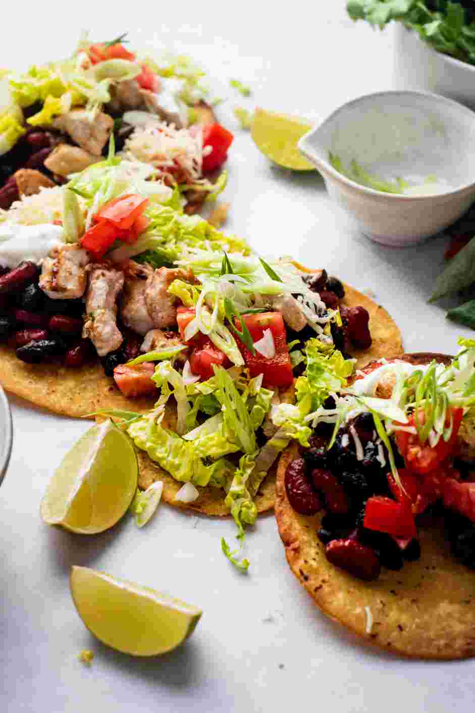 Chicken Tostadas Recipe: Top with sour cream, salsa and sliced scallions.