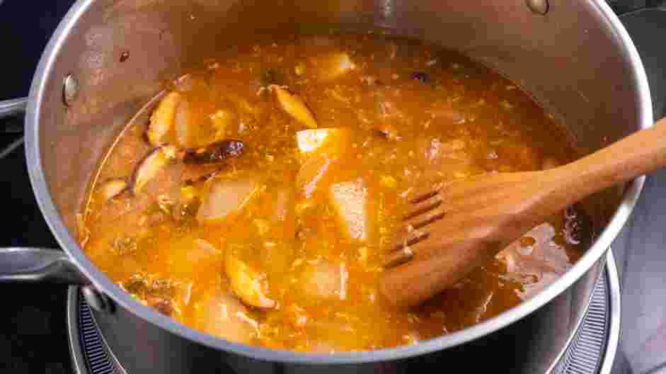 Korean Tofu Soup (Soondubu Jjigae) Recipe: Add the tofu and raw eggs to the simmering soup.