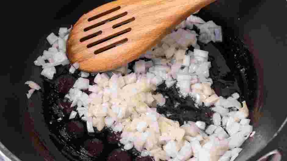 Seafood Risotto Recipe: In a large pan over medium-low heat, sweat the onions in olive oil until translucent.