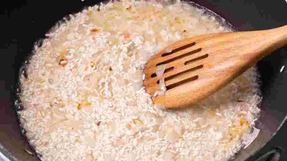 Seafood Risotto Recipe: Add half of the wine, stirring until the wine is almost completely absorbed by the rice.