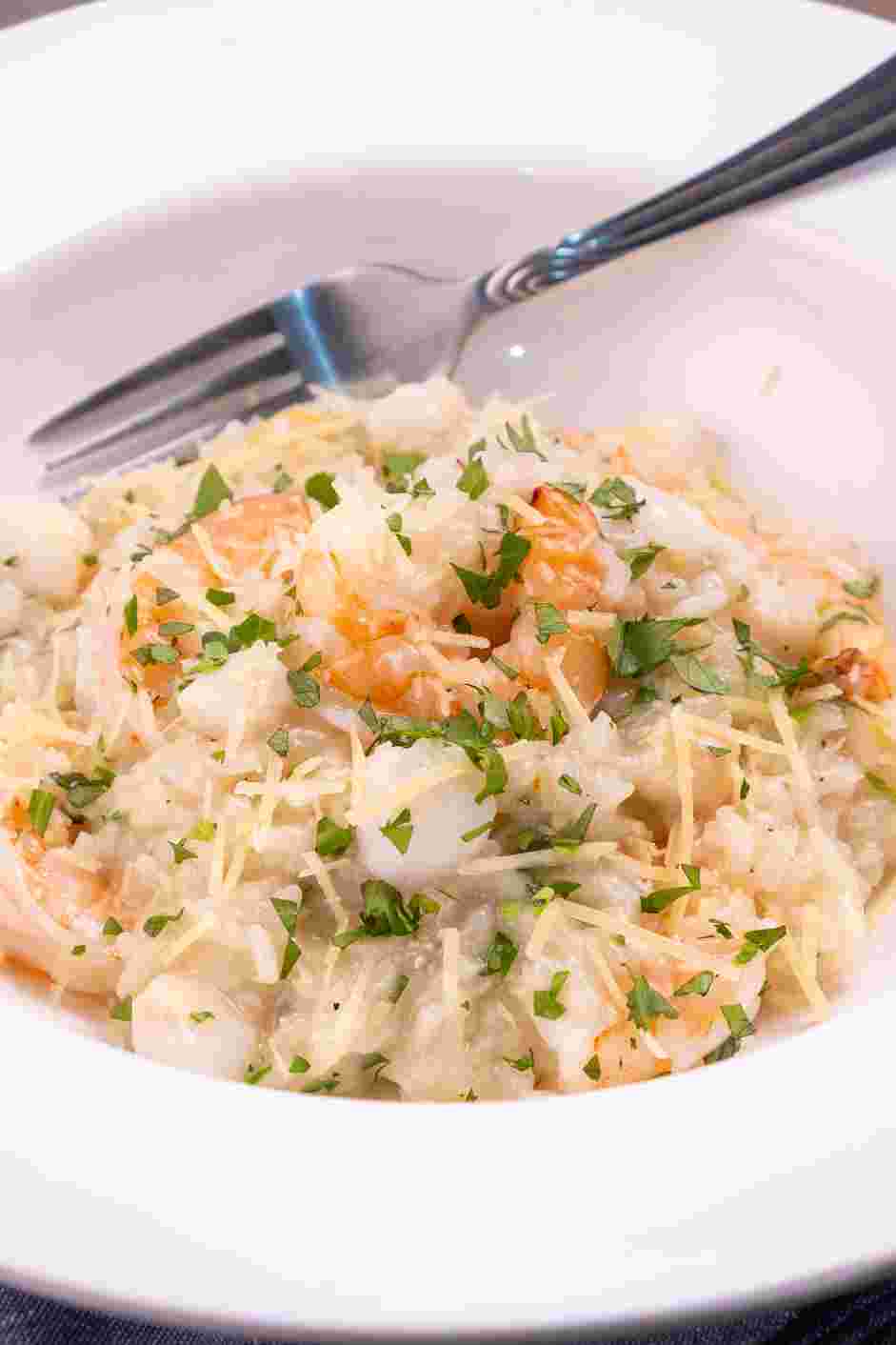 Seafood Risotto Recipe: Serve hot, garnished with more parsley and Parmesan.