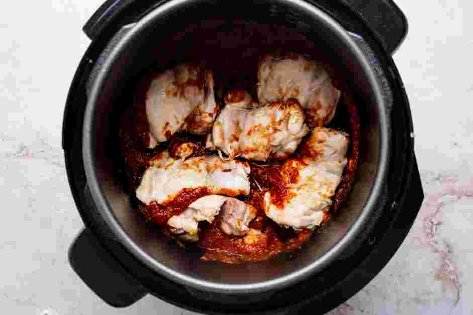 Instant Pot Chicken Tacos Recipe: Place the seared chicken on top and place the lid on the Instant Pot and pressure cook on the manual high setting for 18 minutes with the pressure release valve set to sealing.