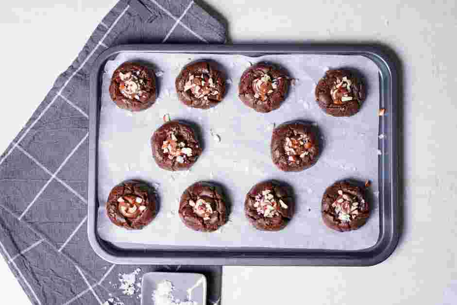 Nutella Cookies Recipe: Top the Nutella center with the chopped hazelnuts and a sprinkling of flaky salt.