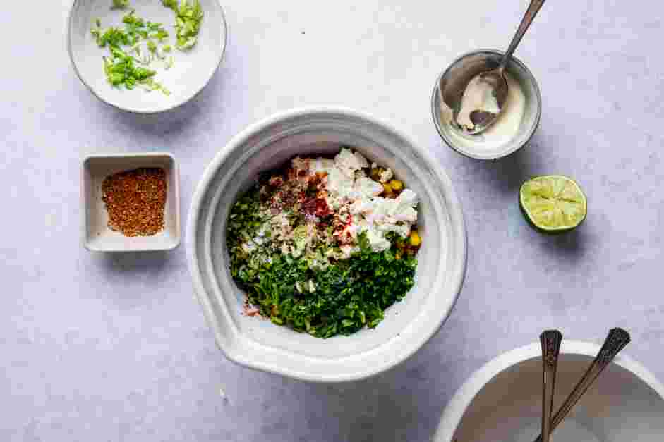 Street Corn Dip Recipe: Transfer the charred corn kernels to a bowl and add the mayonnaise, cojita cheese, smoked paprika, finely chopped scallion, minced garlic, cilantro and lime juice.