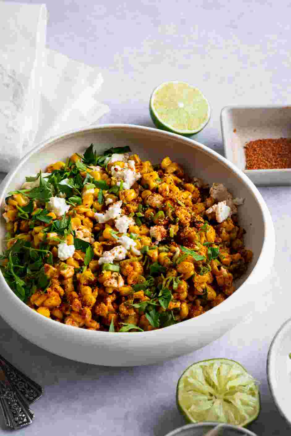 Street Corn Dip Recipe: Place in the serving bowl and top with cojita cheese, tajin and finely chopped cilantro.