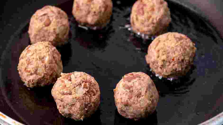 Firecracker Meatballs Recipe: Place the vegetable oil in a frying pan and heat over medium heat.