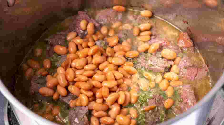 Carne en Su Jugo (Meat in its Juices) Recipe: Stir in the pinto beans and bring the mixture to a boil.