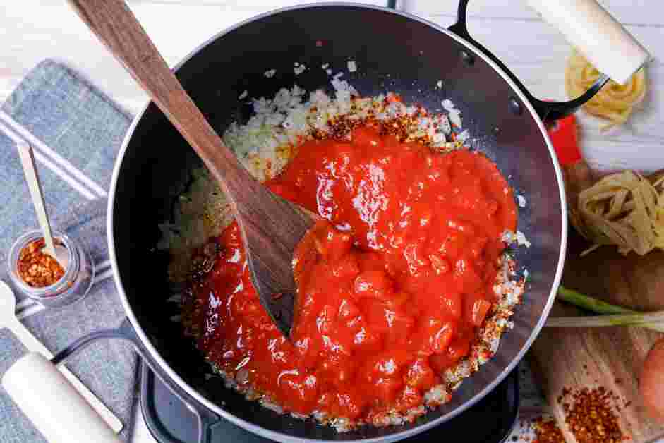 Spicy Marinara Sauce Recipe: Add the red pepper flakes and diced tomatoes.
