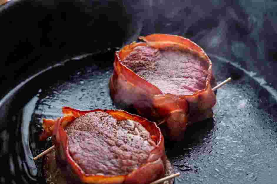 Bacon Wrapped Filet Mignon Recipe: In a large cast-iron skillet, heat the oil.