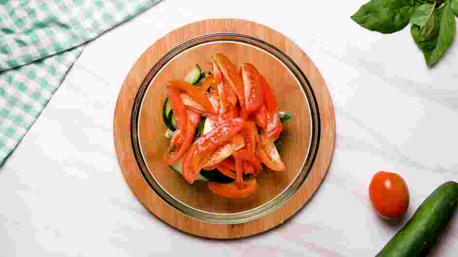 Cucumber Tomato Feta Salad Recipe: Place the cucumber and tomatoes in a bowl.