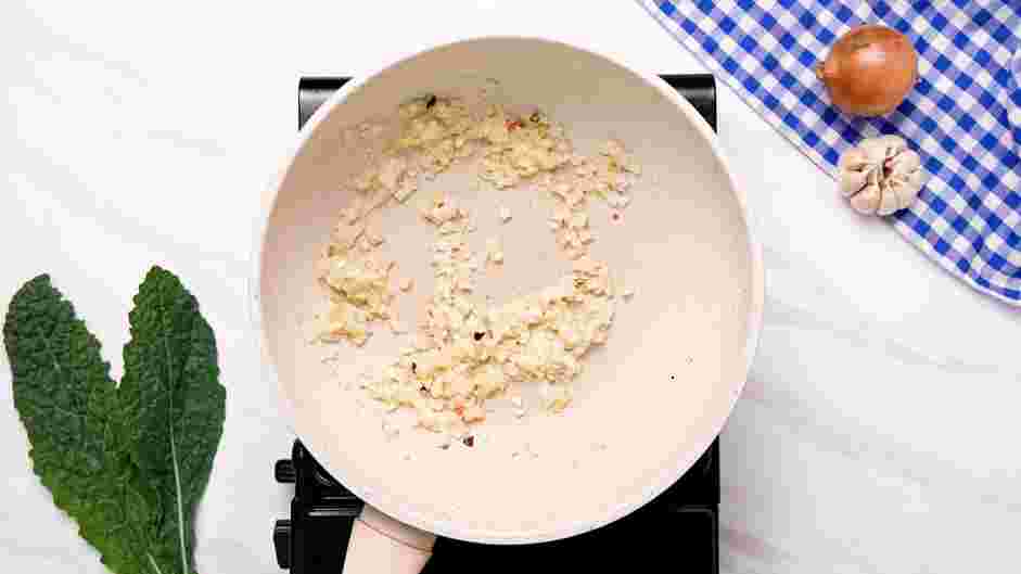 Kale Chicken Bowl Recipe: Add the minced onion, minced garlic and pepper flakes to the skillet.