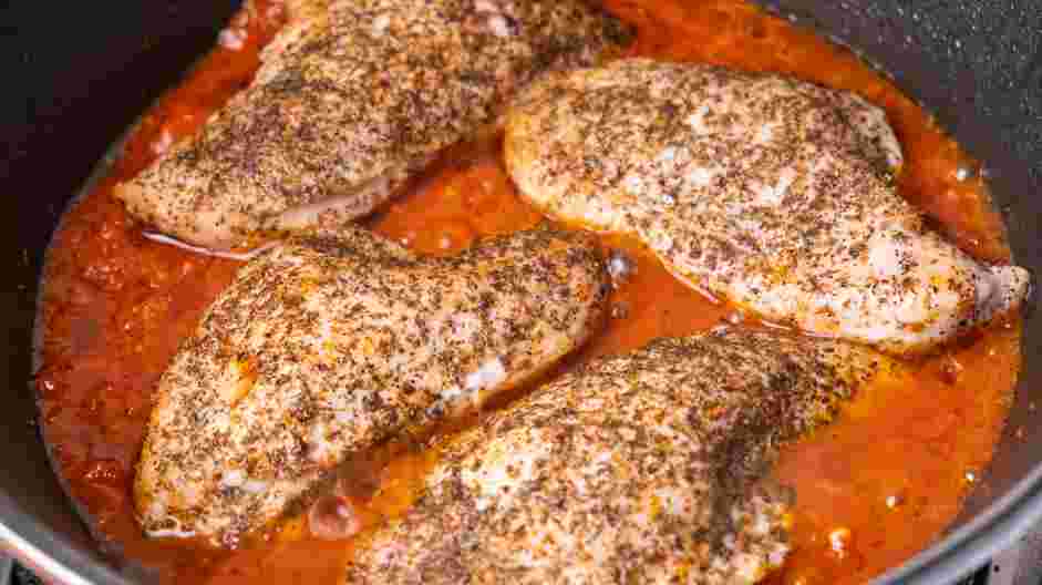 Mozzarella Stuffed Chicken Breast Recipe: Reduce the heat to medium, and add the tomato sauce to the skillet, surrounding the chicken.