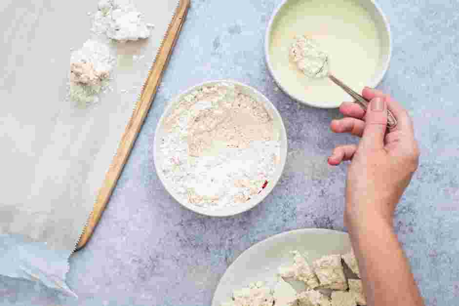 Vegan Fried Chicken Recipe: Dunk several pieces of tofu at a time into the vegan buttermilk.