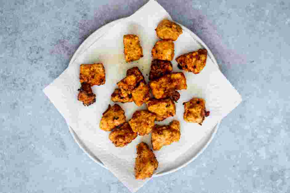 Vegan Fried Chicken Recipe: When the tofu is golden and crispy, transfer to the prepared wire rack and keep warm in the oven while frying the remaining pieces in batches.