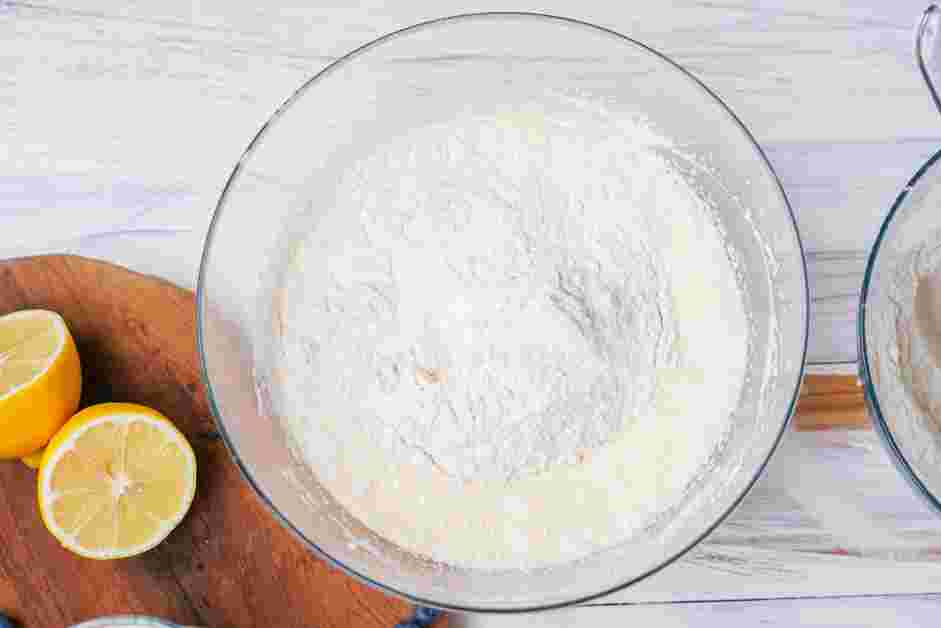 Lemon Blueberry Pound Cake Recipe: Slowly add &frac12; of the flour mixture, then &frac12; of the milk mixture and beat until incorporated.