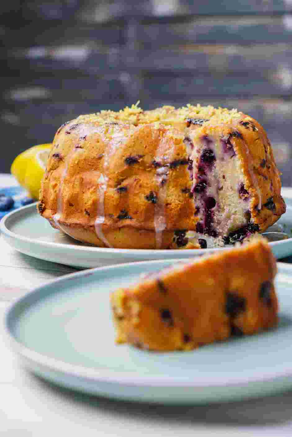 Lemon Blueberry Pound Cake Recipe: Spoon the lemon glaze over the top of the cooled cake and garnish with grated lemon peel.