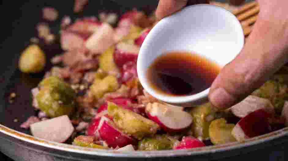 Cowboy Steak with Pan-Fried Radish and Bacon Recipe: Add in balsamic vinegar to deglaze, and stir again.