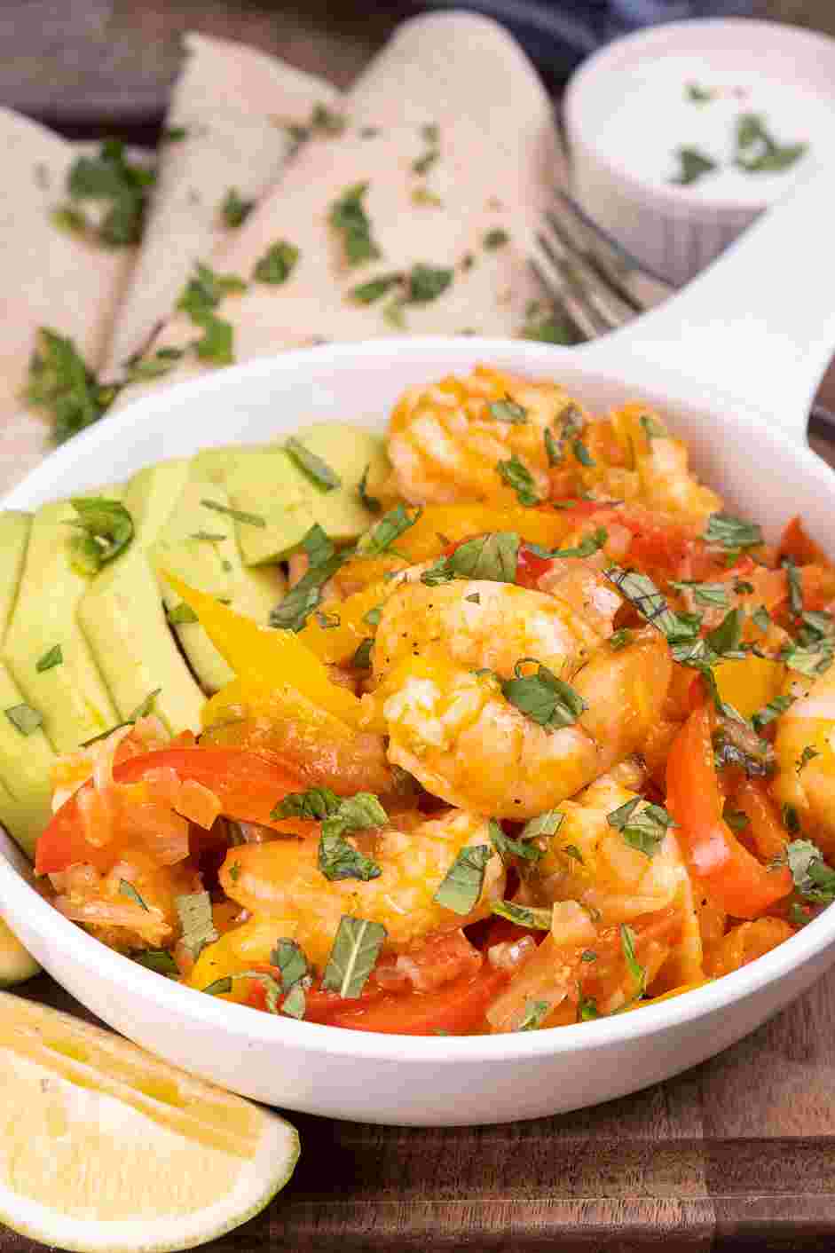 Shrimp Fajitas Recipe: Serve on a large plate with avocado slices, sour cream, and lime wedges on the side.