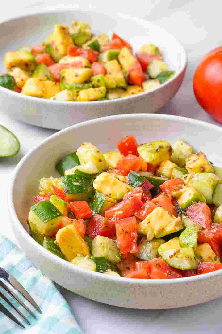 Cucumber Tomato Avocado Salad Recipe: Divide the tomato, cucumbers, and avocado into two bowls or plates.