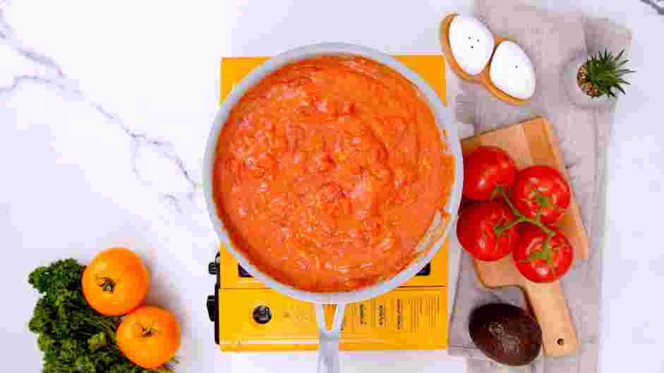 Tomato Gravy Recipe: Once all of the chicken stock is incorporated and a smooth sauce has formed, add the canned diced tomatoes.