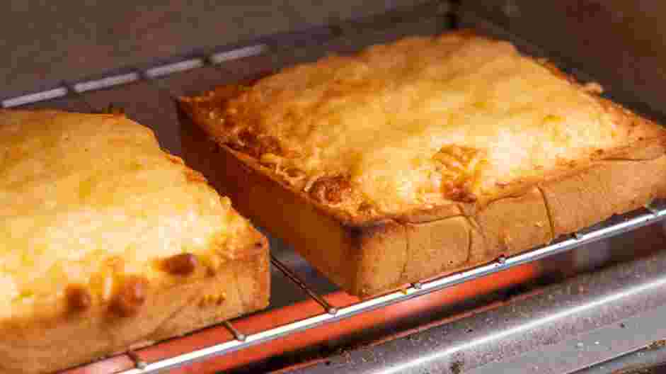 Texas Toast Garlic Bread Recipe: Remove the toast from the oven and sprinkle with the Parmesan cheese.