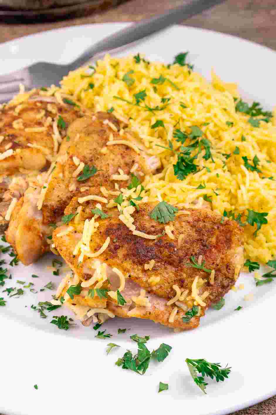 Chicken and Yellow Rice Recipe: Garnish with fresh parsley and enjoy!