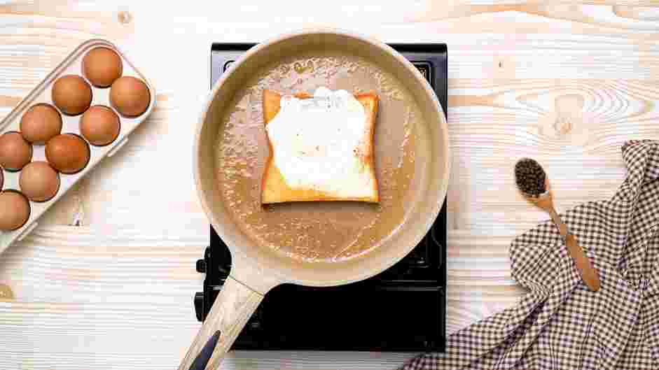 Egg in a Hole Recipe: Flip the toast and cook for about 15 seconds.