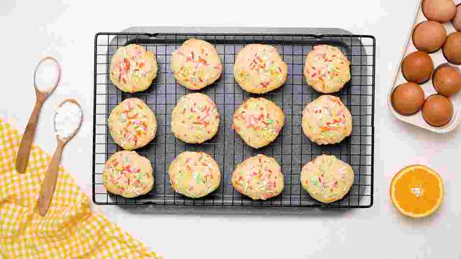 Funfetti Cookies Recipe: Remove the pans from the oven and slide the parchment paper with the cookies onto your countertop or a cooling rack.