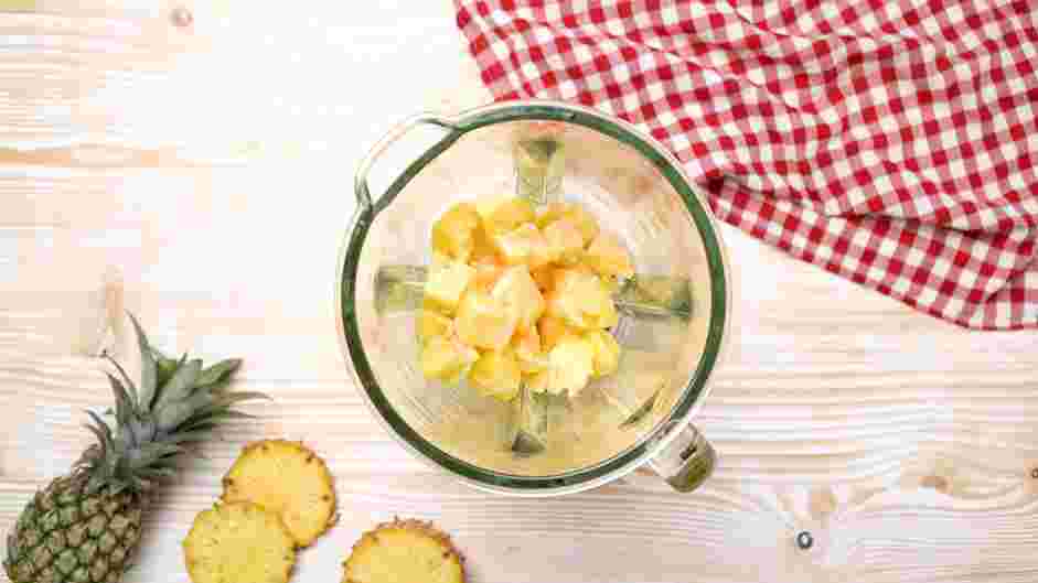 Pineapple Whip Recipe: In the jar of a high-speed blender, add the frozen pineapple chunks, milk and condensed milk.