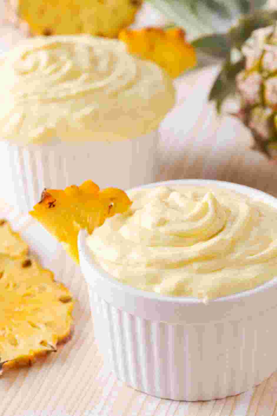 Pineapple Whip Recipe: Pipe the pineapple whip into serving cups and garnish with pineapple slices.