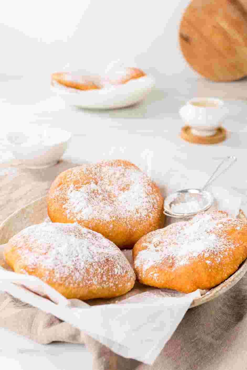 Fried Dough Recipe: Top the fried dough with a generous dusting of confectioners&rsquo; sugar.