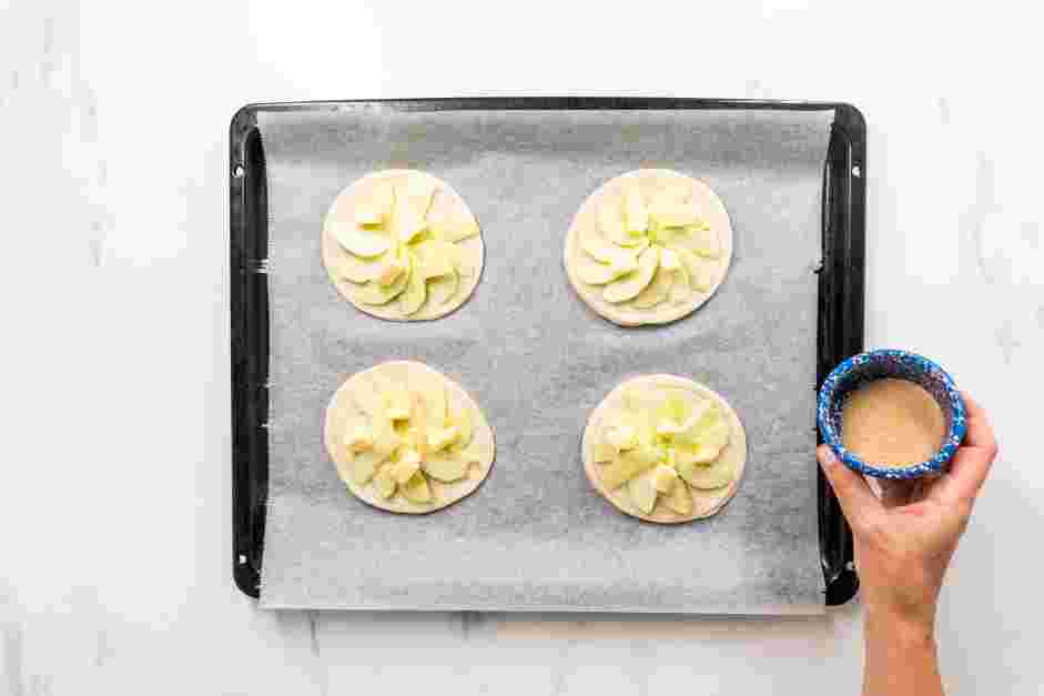 Apple Tartlets Recipe: Use a paring knife to score a &frac12;-inch border around each circle.