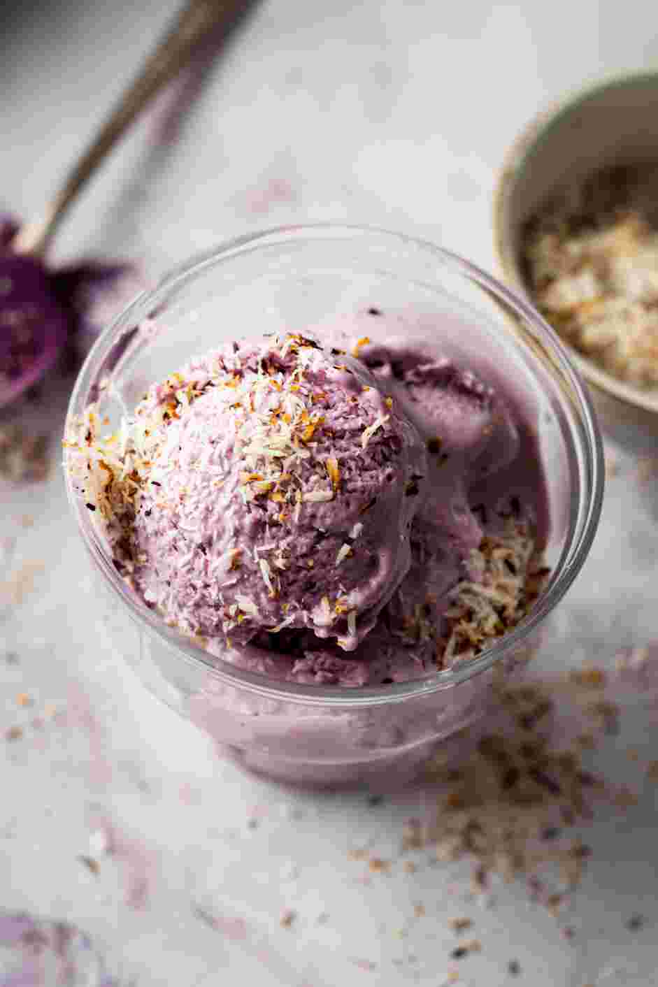 Ube Ice Cream Recipe: Serve the ube ice cream in a bowl or a cone topped with a sprinkling of toasted coconut flakes.