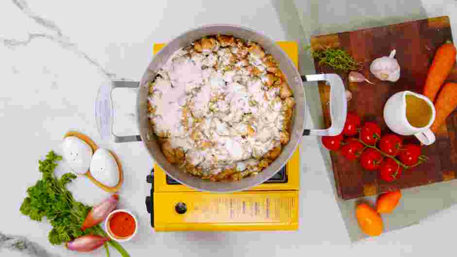 Creamy Chicken and Dumplings Recipe: Once most of the chicken is cooked, add the flour to the pot and stir until well incorporated.