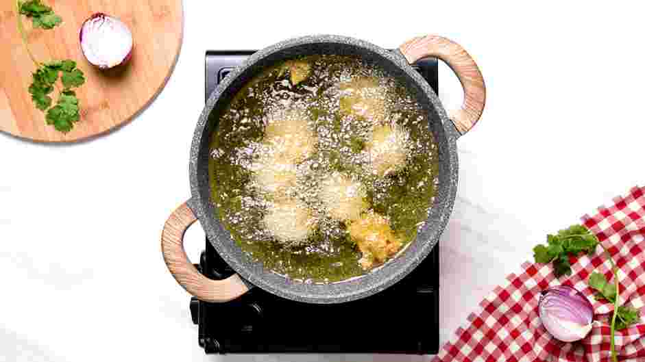 Chicken Pakora Recipe: In a large pot, heat the canola oil until it reaches 350°F.