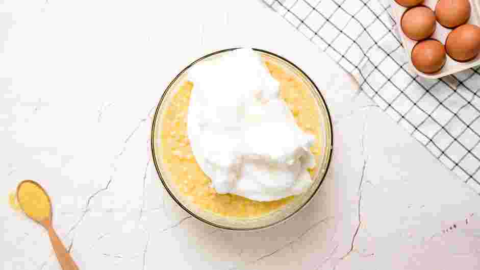 Corn Souffle Recipe: Fold the egg whites into the corn mixture.