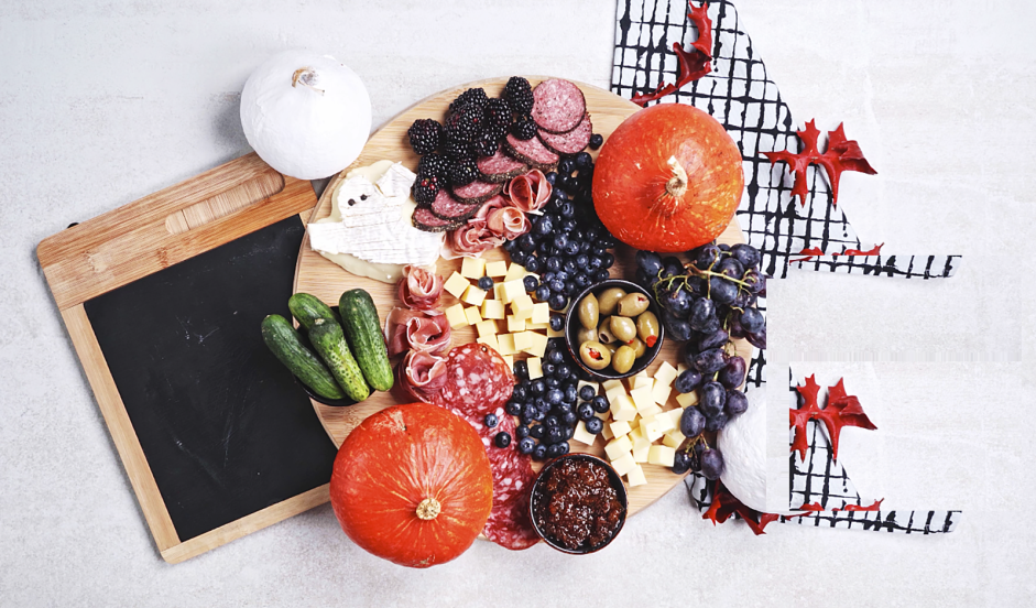 Halloween Charcuterie Board Recipe: Add the blackberries, blueberries and black grapes in bunches along any empty spaces of the board.