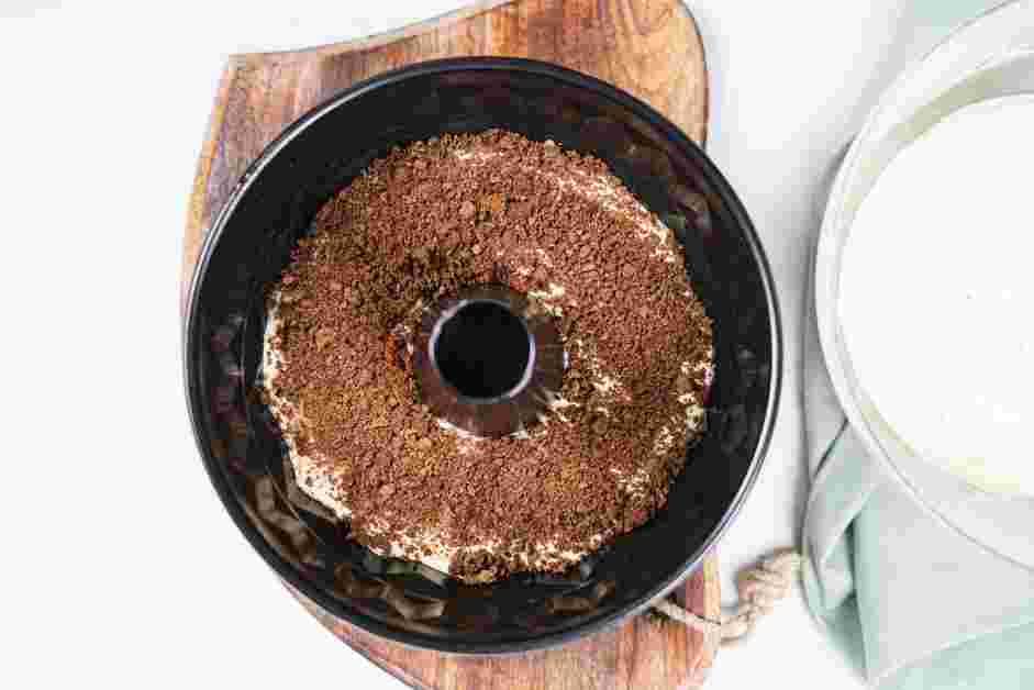 Honey Bun Cake Recipe: Pour half of the cake batter into the prepared bundt pan and top with half of the cinnamon filling.