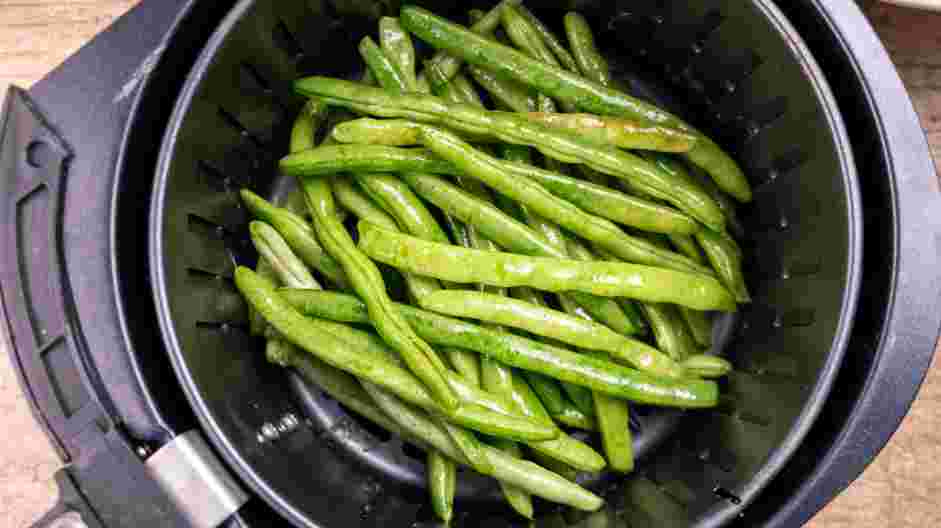 Air Fryer Green Beans Recipe: Place the green beans in the air fryer basket and air fry for 5 minutes.