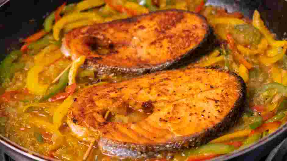 Salmon Steaks with Roasted Chile Medley and Turmeric Rice Recipe: Nestle the salmon steaks back in the pan and cover the pan with the lid.