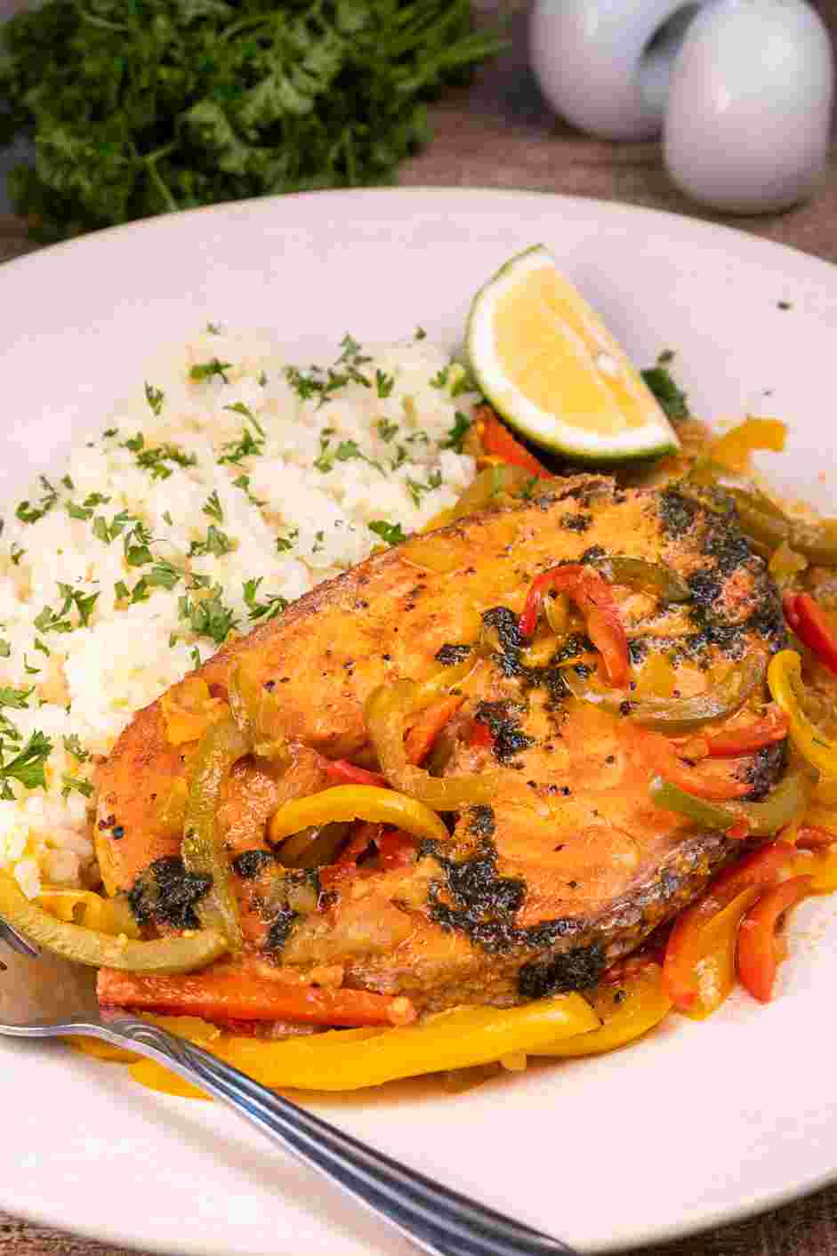 Salmon Steaks with Roasted Chile Medley and Turmeric Rice Recipe: Plate turmeric rice, then the salmon steaks.