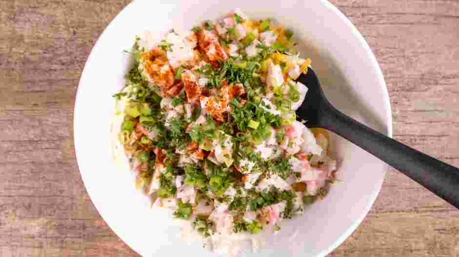 Shrimp and Crab Dip Recipe: In a mixing bowl, combine the lump crab meat, shrimp, cream cheese, chopped green onion, Mexican blend cheese, seafood seasoning, lemon juice, paprika and fresh parsley.