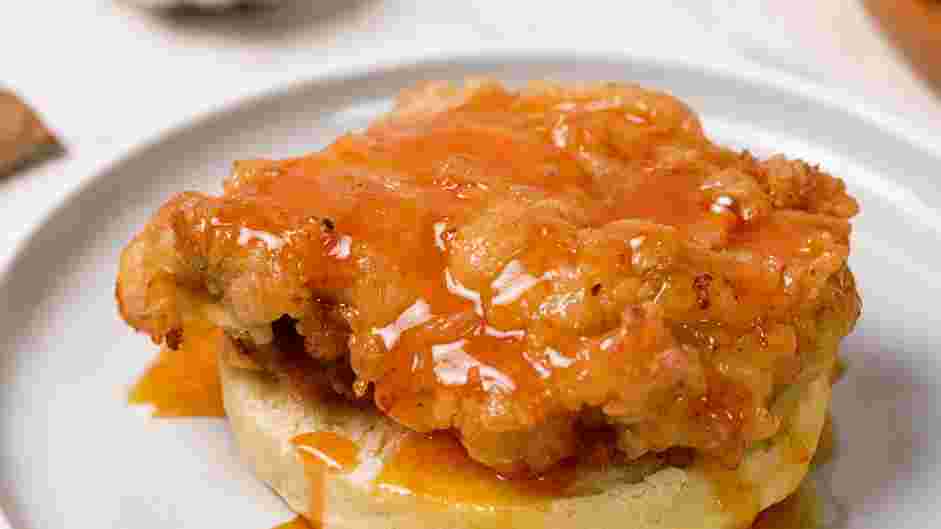 Honey Butter Chicken Biscuit Recipe: Place a piece of the fried chicken thigh on the biscuit and pour the warm honey butter sauce on top of the chicken and biscuit.