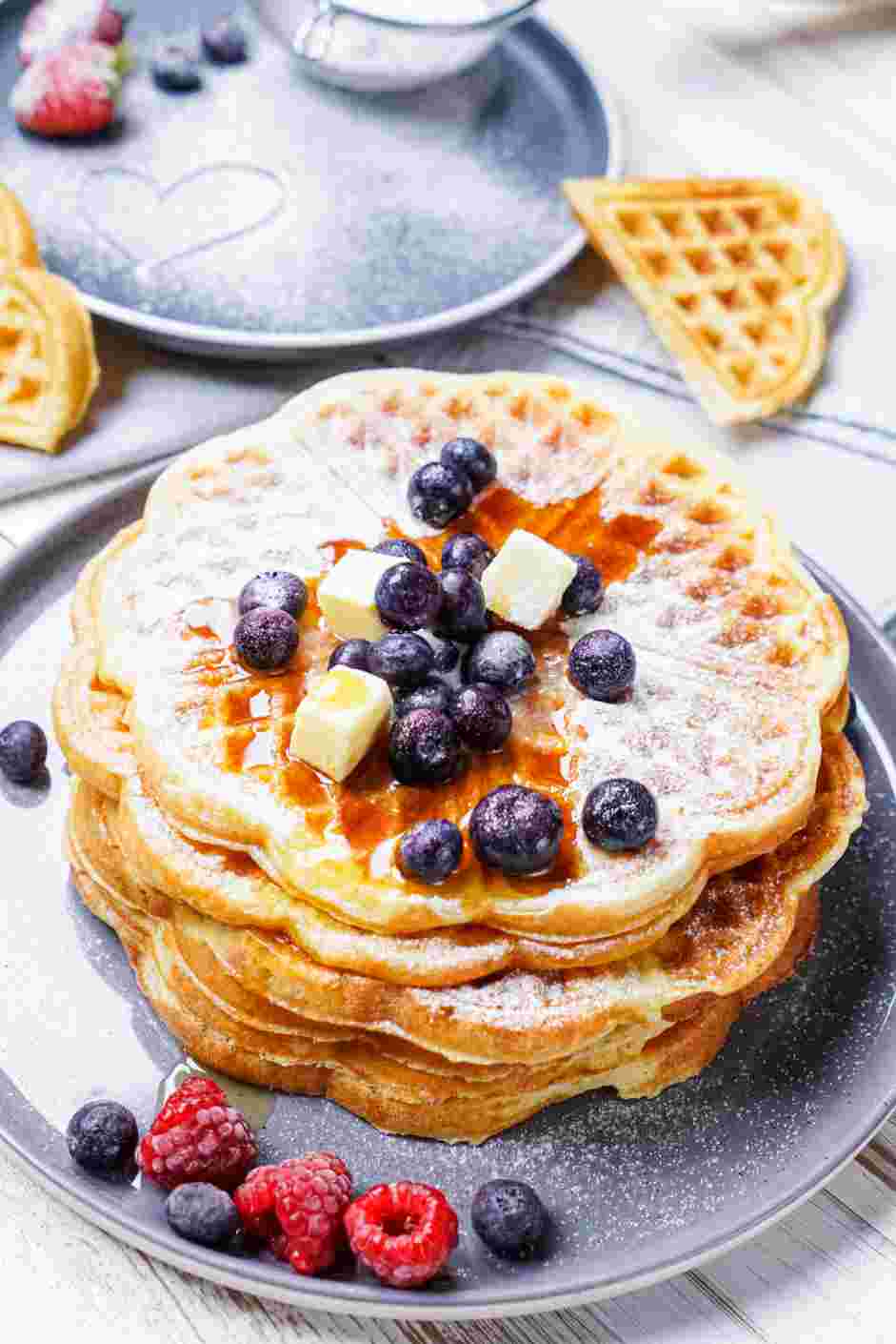 Gluten Free Waffles Recipe: Serve topped with berries, a dusting of powdered sugar, a pat of butter and maple syrup.